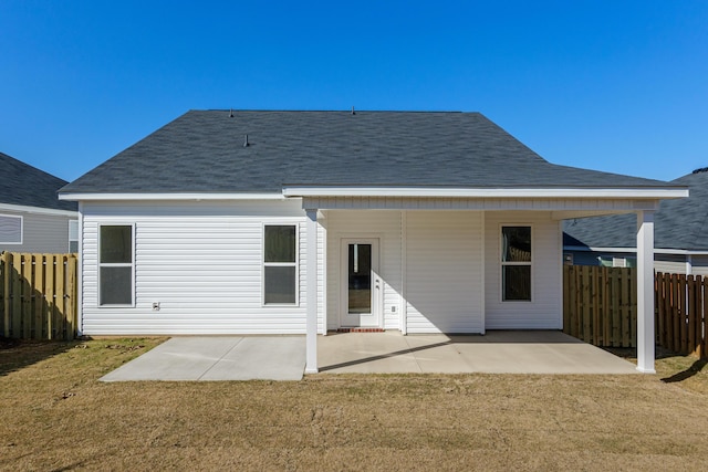 rear view of property with a patio and a yard