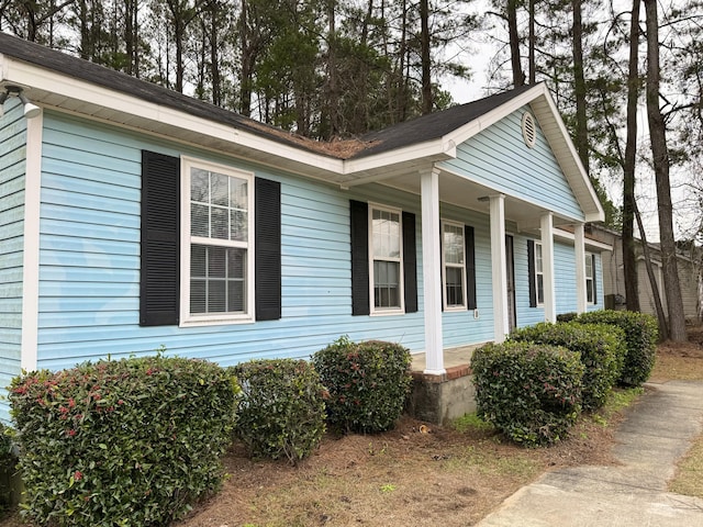 view of property exterior with covered porch