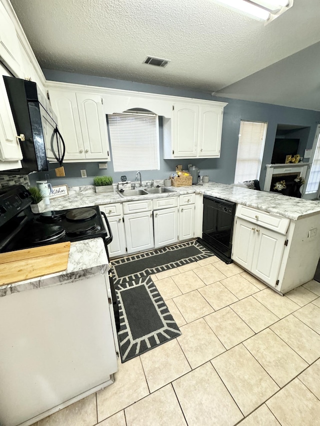 kitchen with sink, white cabinets, a textured ceiling, kitchen peninsula, and black appliances