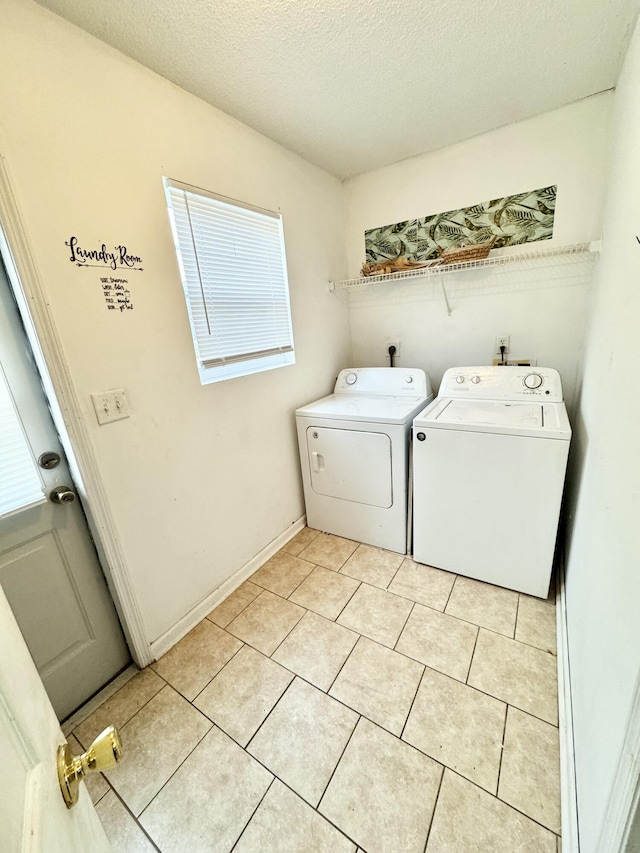 washroom featuring independent washer and dryer, a textured ceiling, and light tile patterned floors