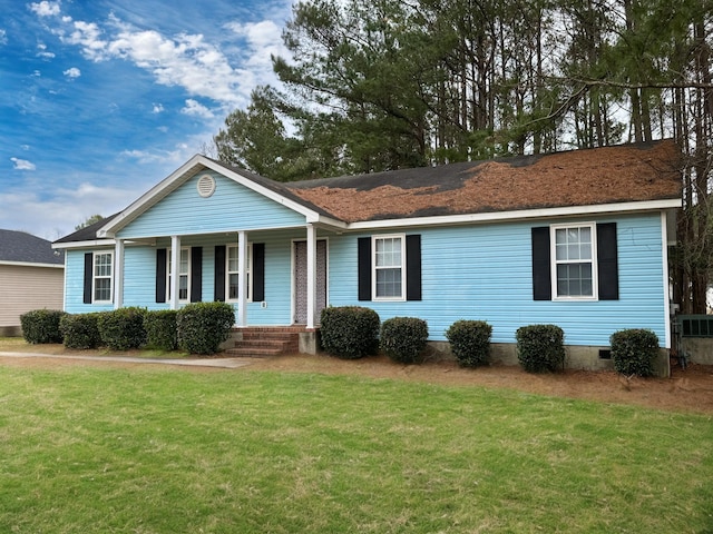 ranch-style house with covered porch and a front lawn