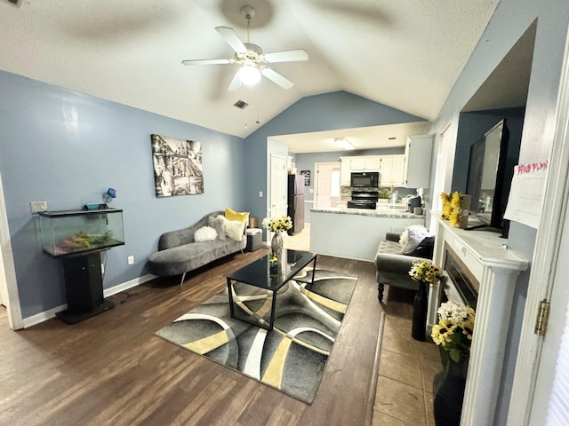 living room featuring lofted ceiling, ceiling fan, and dark hardwood / wood-style flooring