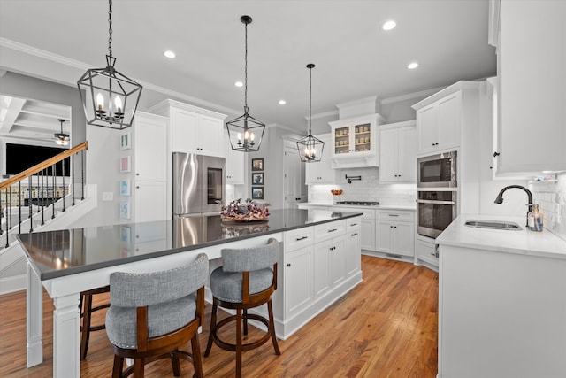 1037 Bartram Rdg, Evans, GA 30809 - kitchen with appliances with stainless steel finishes, crown molding, recessed lighting, tasteful backsplash, and a chandelier