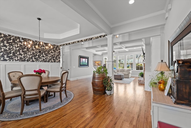 1037 Bartram Rdg, Evans, GA 30809 - dining space featuring a chandelier, a decorative wall, crown molding, light wood-type flooring, and decorative columns