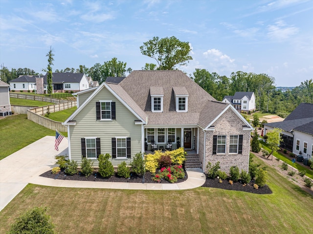 1037 Bartram Rdg, Evans, GA 30809 - traditional home with covered porch, brick siding, roof with shingles, a residential view, and concrete driveway
