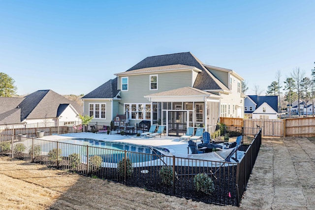 1037 Bartram Rdg, Evans, GA 30809 - view of swimming pool featuring a sunroom, a patio, a fenced backyard, and a residential view