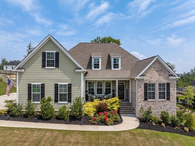 1037 Bartram Rdg, Evans, GA 30809 - traditional home with a porch, a front yard, a shingled roof, and brick siding