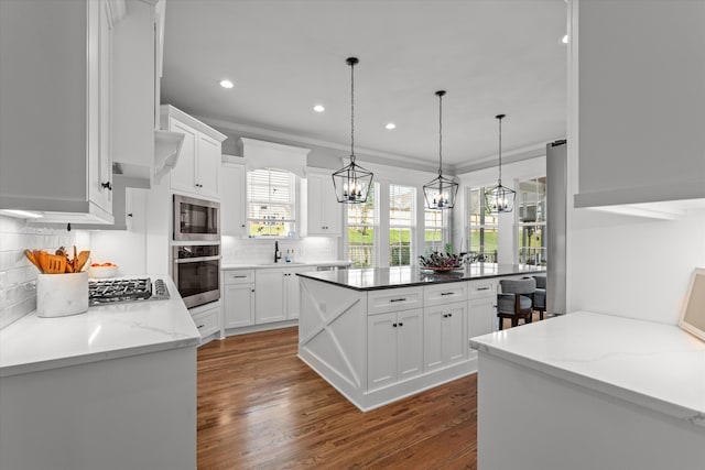 1037 Bartram Rdg, Evans, GA 30809 - kitchen with stainless steel appliances, a chandelier, backsplash, white cabinetry, and recessed lighting
