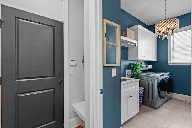 1037 Bartram Rdg, Evans, GA 30809 - washroom featuring independent washer and dryer, a chandelier, and cabinet space