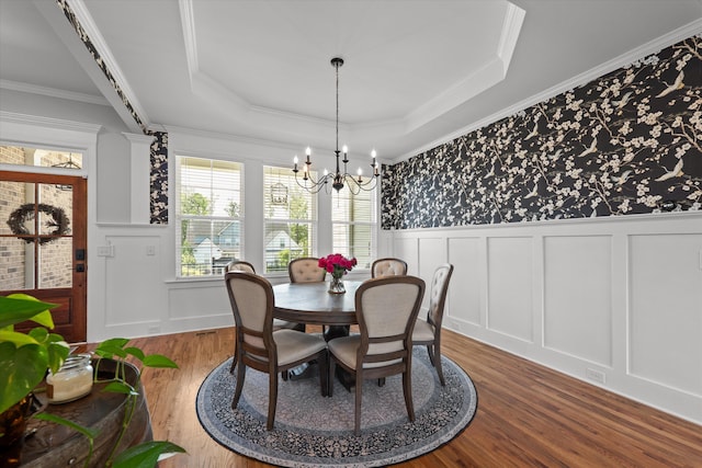 1037 Bartram Rdg, Evans, GA 30809 - dining space with wood finished floors, plenty of natural light, a decorative wall, a chandelier, and a tray ceiling