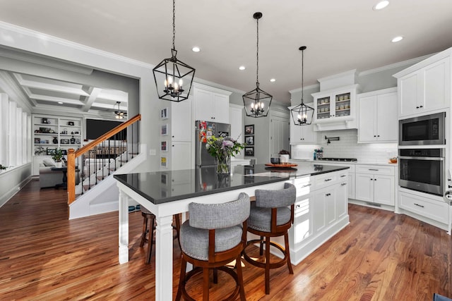 1037 Bartram Rdg, Evans, GA 30809 - kitchen featuring stainless steel appliances, recessed lighting, crown molding, dark countertops, and a center island