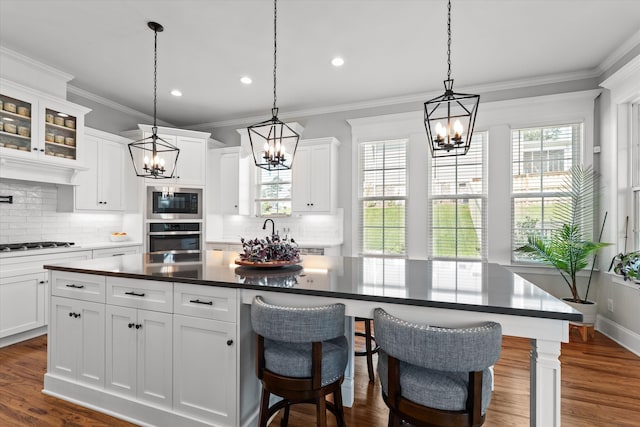 1037 Bartram Rdg, Evans, GA 30809 - kitchen featuring appliances with stainless steel finishes, a chandelier, tasteful backsplash, dark wood-type flooring, and recessed lighting