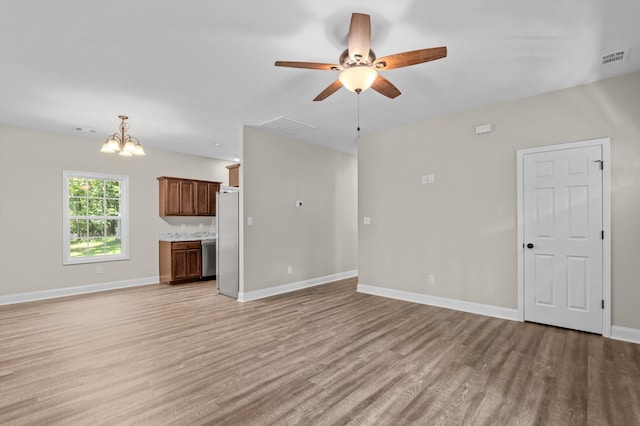 502 Shadowmoor Ct, Thomson, GA 30824 - unfurnished living room with light wood-style flooring, a ceiling fan, and a chandelier