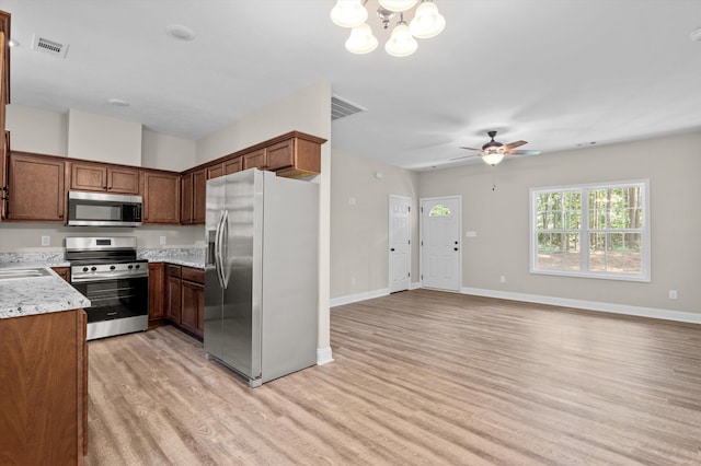 502 Shadowmoor Ct, Thomson, GA 30824 - kitchen featuring appliances with stainless steel finishes, light wood-type flooring, a ceiling fan, a chandelier, and open floor plan
