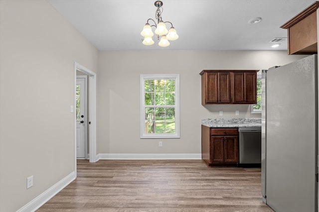 502 Shadowmoor Ct, Thomson, GA 30824 - kitchen with appliances with stainless steel finishes, light wood finished floors, a chandelier, pendant lighting, and dark brown cabinetry