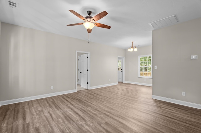 502 Shadowmoor Ct, Thomson, GA 30824 - spare room with wood finished floors, a ceiling fan, and a chandelier
