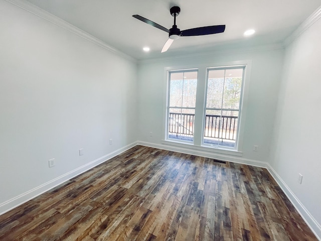 unfurnished room with ornamental molding, dark wood-type flooring, and baseboards