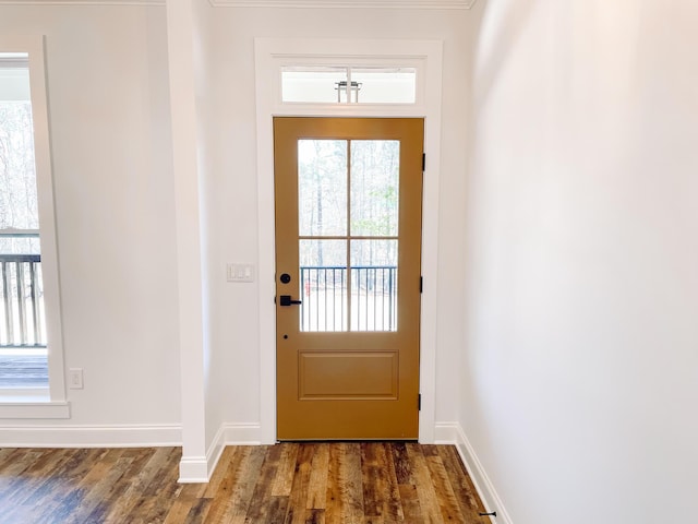 doorway with wood finished floors and baseboards