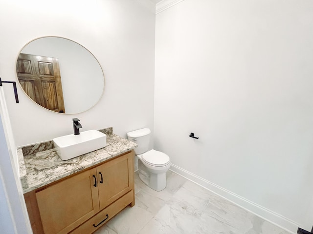 bathroom with toilet, marble finish floor, baseboards, and vanity