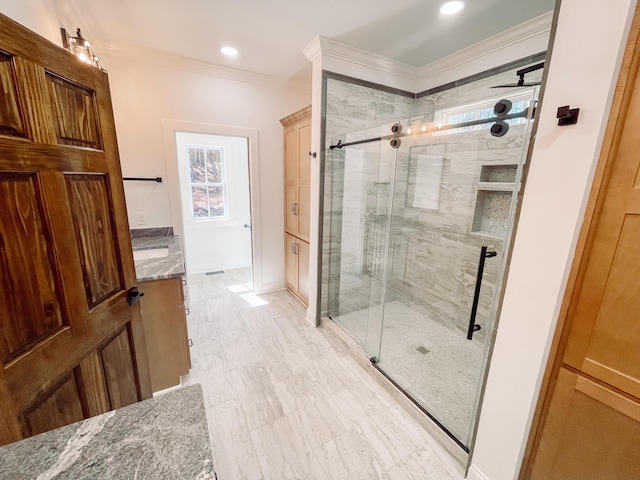 bathroom featuring a stall shower, crown molding, vanity, and baseboards