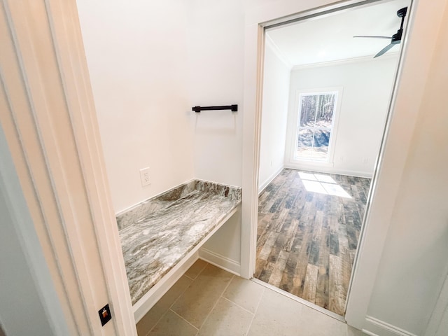 bathroom with ornamental molding, a wealth of natural light, ceiling fan, and wood finished floors