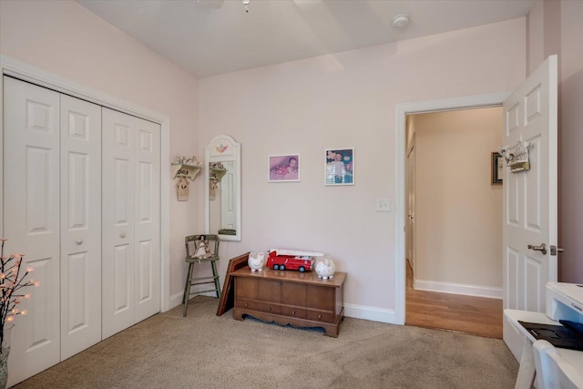 bedroom featuring light colored carpet and a closet