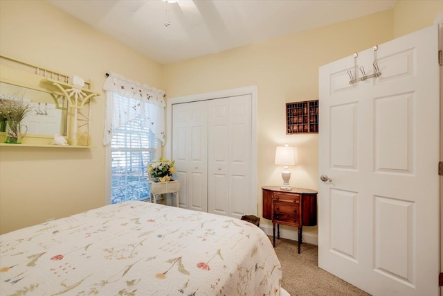 bedroom with a closet, ceiling fan, and carpet