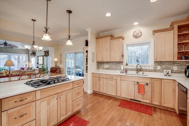 kitchen with pendant lighting, light brown cabinets, a healthy amount of sunlight, sink, and stainless steel gas cooktop