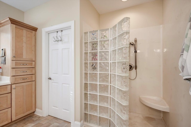 bathroom with walk in shower and vanity