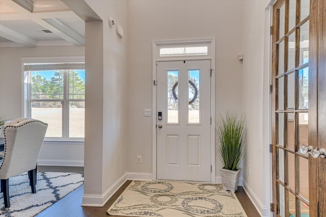 entrance foyer with beam ceiling, a wealth of natural light, dark hardwood / wood-style flooring, and coffered ceiling