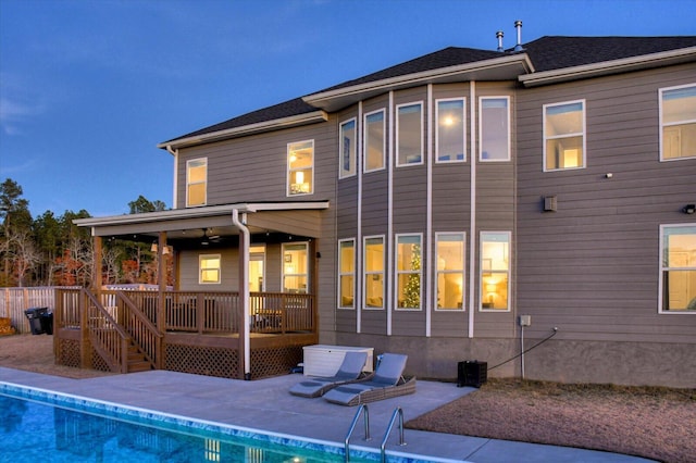 rear view of property featuring a deck and a patio area