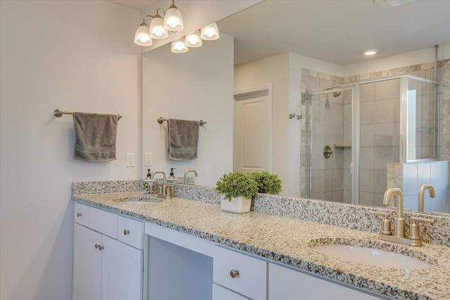 bathroom featuring vanity and a shower with shower door