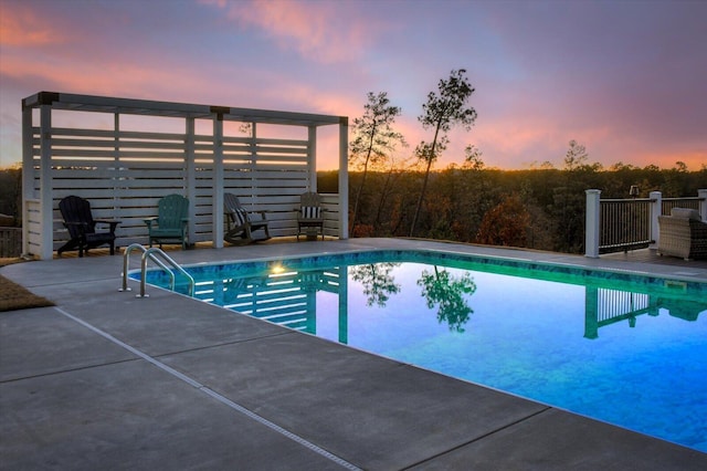 pool at dusk featuring a patio