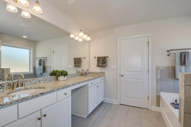 bathroom featuring tile patterned flooring, vanity, and a bathtub