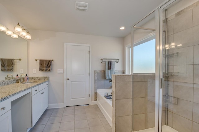 bathroom featuring tile patterned flooring, vanity, and shower with separate bathtub