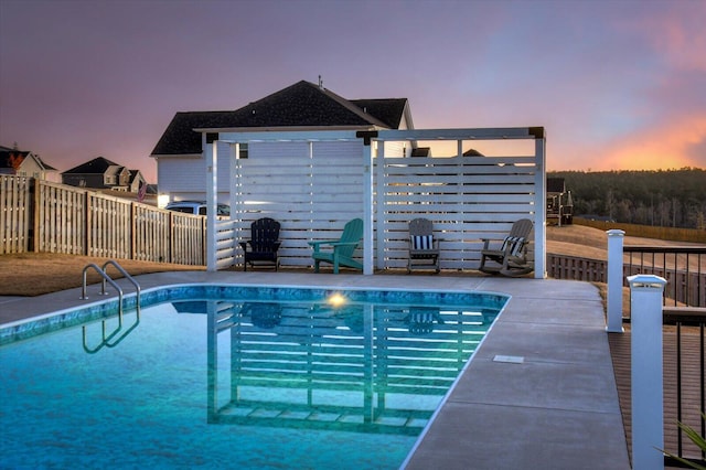 pool at dusk with a patio