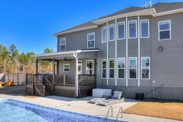 rear view of house with a swimming pool side deck, a patio area, and ceiling fan