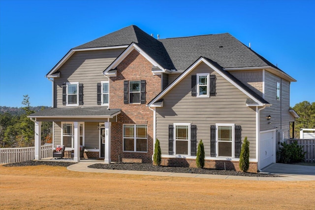 view of front facade featuring covered porch and a garage