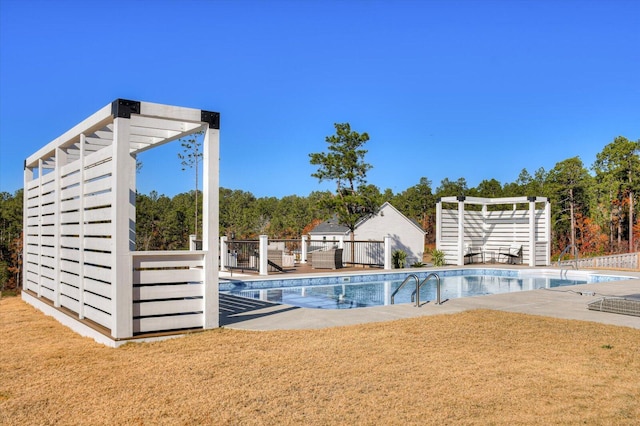 view of pool with a patio area and a yard