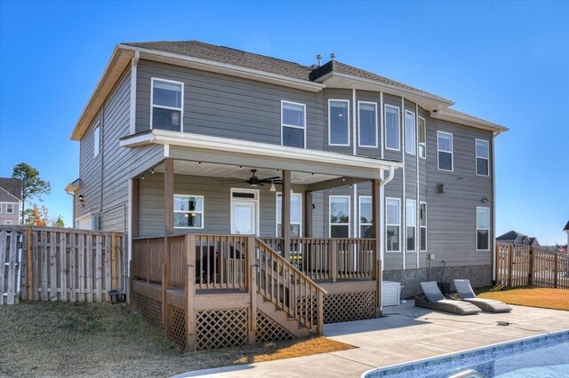 back of property with a pool side deck, ceiling fan, and a patio