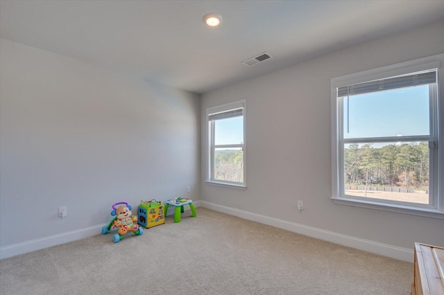 rec room featuring light colored carpet