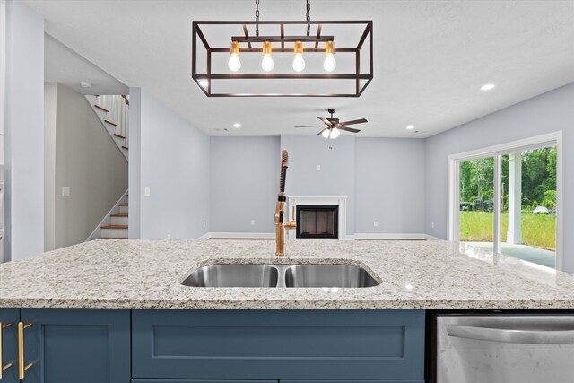 651 Moose Club Rd, Thomson, GA 30824 - kitchen featuring a sink, stainless steel dishwasher, blue cabinets, recessed lighting, and open floor plan