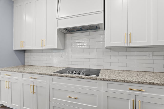 651 Moose Club Rd, Thomson, GA 30824 - kitchen featuring white cabinets, black electric stovetop, and tasteful backsplash