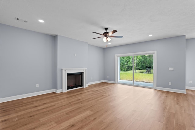 651 Moose Club Rd, Thomson, GA 30824 - unfurnished living room with light wood-style flooring, ceiling fan, recessed lighting, a fireplace, and baseboards