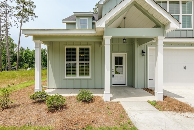 651 Moose Club Rd, Thomson, GA 30824 - entrance to property featuring board and batten siding, covered porch, and a garage
