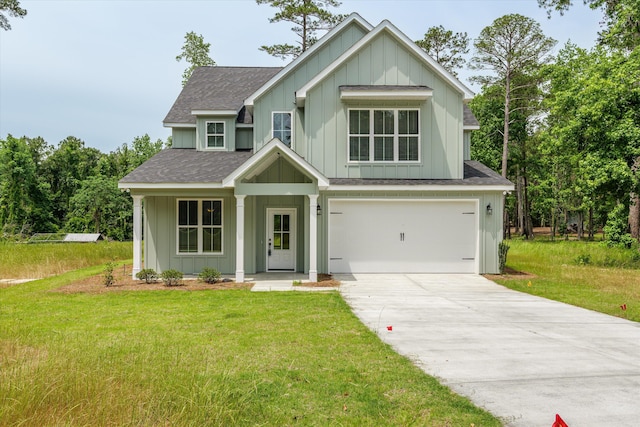 651 Moose Club Rd, Thomson, GA 30824 - view of front of home featuring board and batten siding, roof with shingles, concrete driveway, a front yard, and a garage