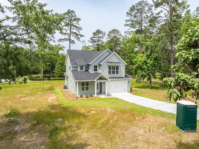 651 Moose Club Rd, Thomson, GA 30824 - traditional-style house with a shingled roof, an attached garage, driveway, a front lawn, and board and batten siding