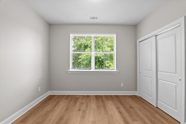651 Moose Club Rd, Thomson, GA 30824 - unfurnished bedroom with light wood-type flooring, baseboards, and a closet