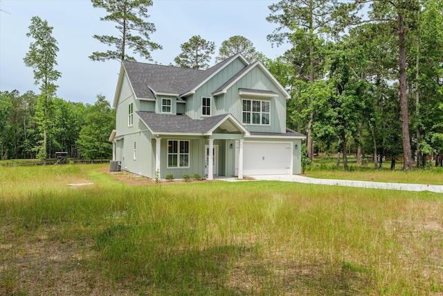 651 Moose Club Rd, Thomson, GA 30824 - view of front of home with roof with shingles, board and batten siding, a garage, driveway, and cooling unit