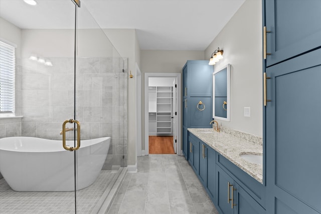 651 Moose Club Rd, Thomson, GA 30824 - bathroom featuring a walk in closet, a shower stall, a soaking tub, double vanity, and tile patterned flooring